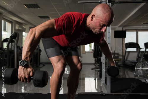 Muscular Man Doing Heavy Weight Exercise For Back