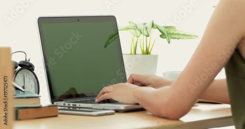 Wallpaper Mural Over the shoulder shot of an Asian woman typing on a laptop computer with a key green screen . Torontodigital.ca