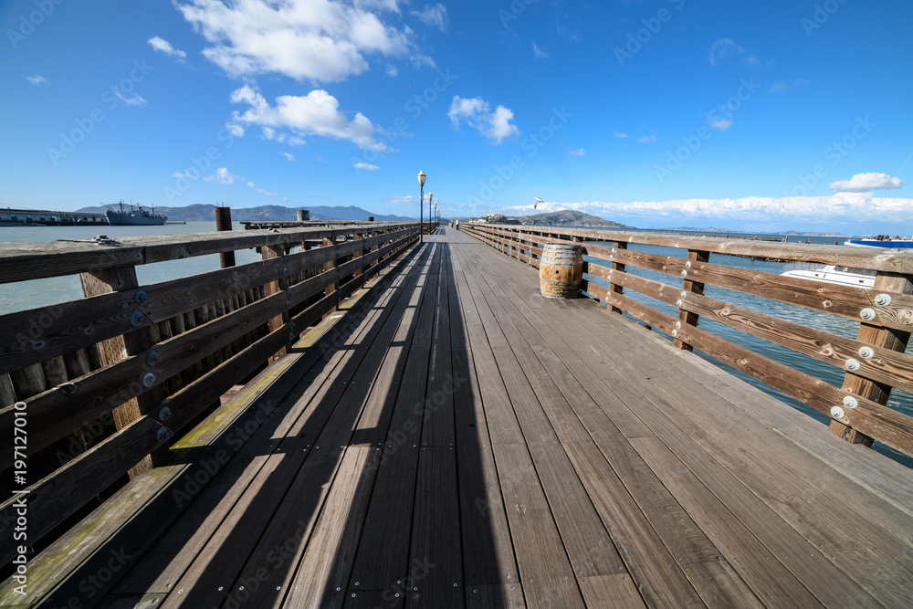 Ocean wooden pier in San Francisco Bay at hot summer day
