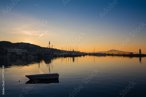 A rowboat watches an amazing sunset