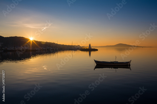 A rowboat watches an amazing sunset © coob.kz