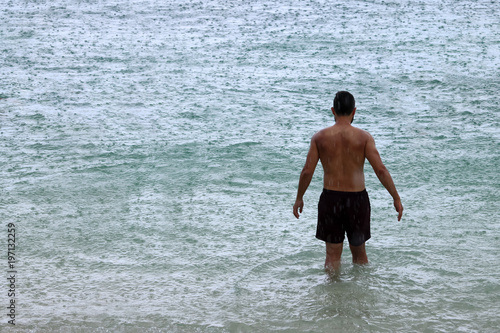 Tourists enjoy activities while raining on the beach,Rainy season in Thailand.