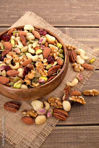 Mixed nuts in wooden bowl with linen mat
