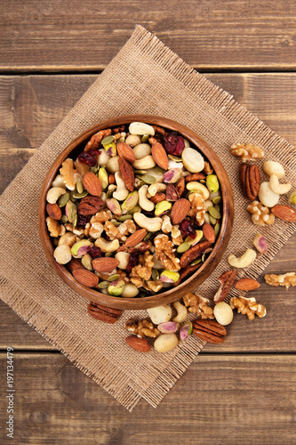 Mixed nuts in wooden bowl with linen mat