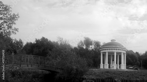 bridge and rotunda in the city park black and white timelapse