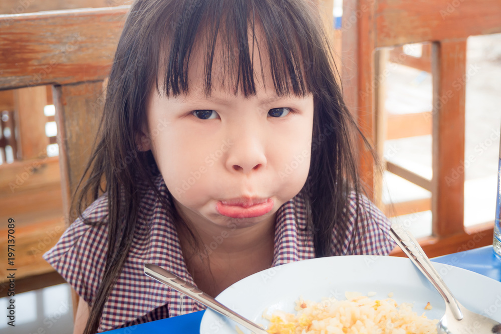Little asian girl refusing to eat fried rice for lunch Little asian girl refusing to eat fried rice for lunch