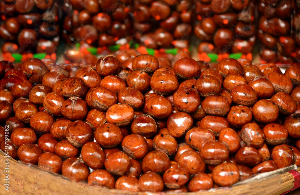 Chestnut in an old wooden table basket with raw pastry area for a fresh Christmas tree chestnut food background Chestnut in an old wooden table basket with raw pastry area for a fresh Christmas tree chestnut food background