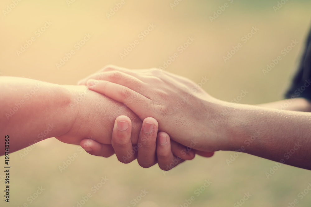 people old and young hand holding with sunset background - obrazy, fototapety, plakaty 