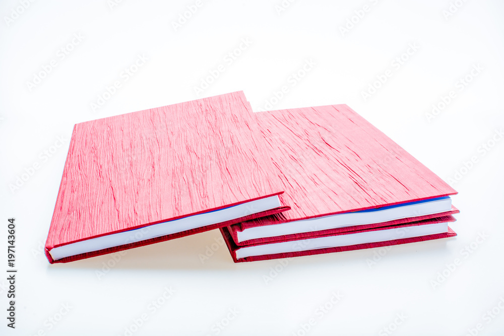 Red notebook isolated on white background. Concept of knowledge and education Red notebook isolated on white background. Concept of knowledge and education