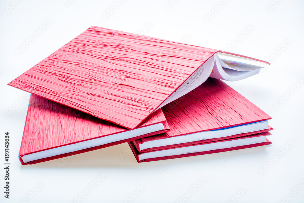 Red notebook isolated on white background. Concept of knowledge and education Red notebook isolated on white background. Concept of knowledge and education