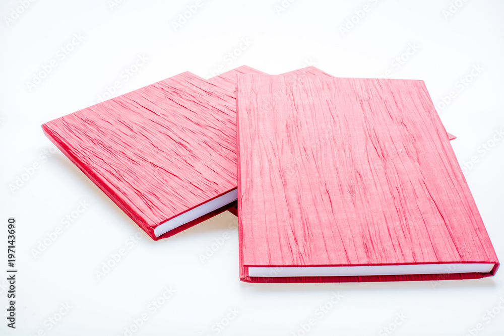 Red notebook isolated on white background. Concept of knowledge and education Red notebook isolated on white background. Concept of knowledge and education