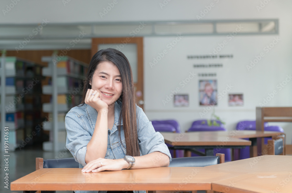 Confident smiling student asian girl in the library university Confident smiling student asian girl in the library university