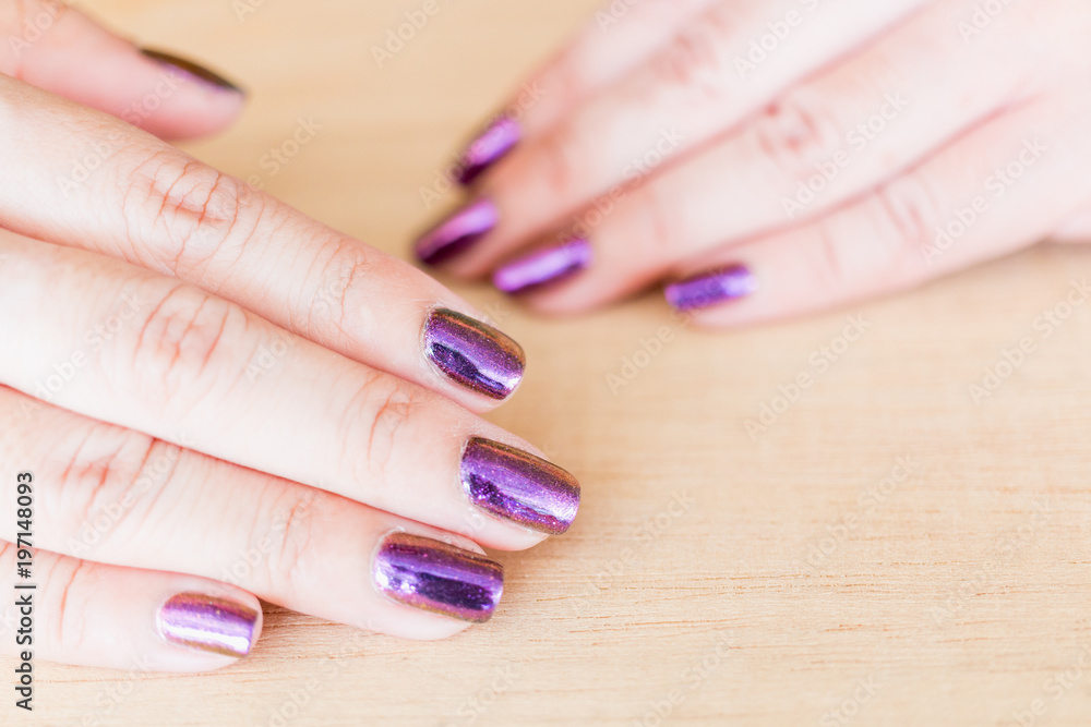 Beautiful nail polish in hand, Purple nail art manicure, Woman's hand
Beautiful nail polish in hand, Purple nail art manicure, Woman's hand