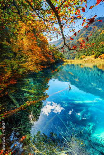 Fantastic autumn landscape. Amazing lake with azure water