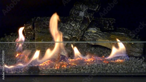 One Biofireplace burn on ethanol gas. Contemporary mount biofuel on ethanol fireplot fireplace close-up. Decorated bio fireplace. Modern smart ecological technologies. photo