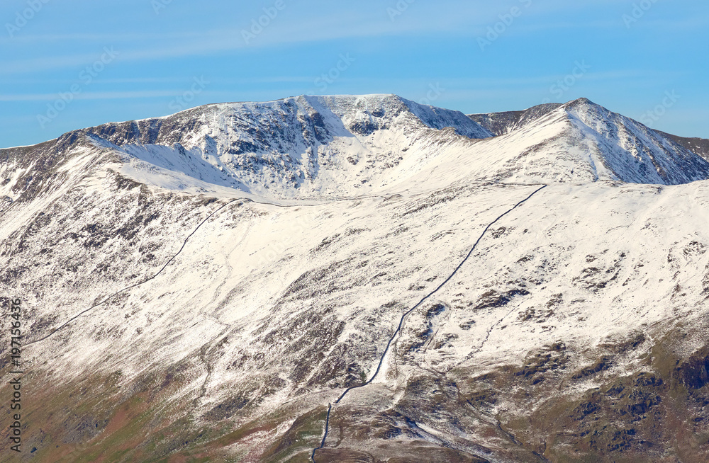 Snow covered mountains of Helvellyn, Striding Edge and Swirral Edge in the Lake District, England, UK.