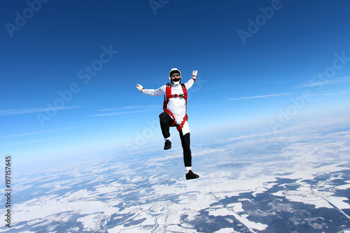 Solo skydiver is in the sky.