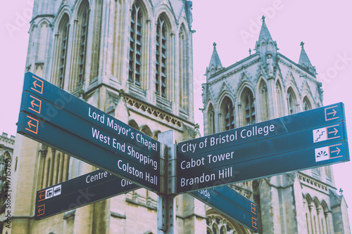 Bristol Tourist Signpost, West Facade Towers of Bristol Cathedral in background, split toning shallow depth of field horizontal photography