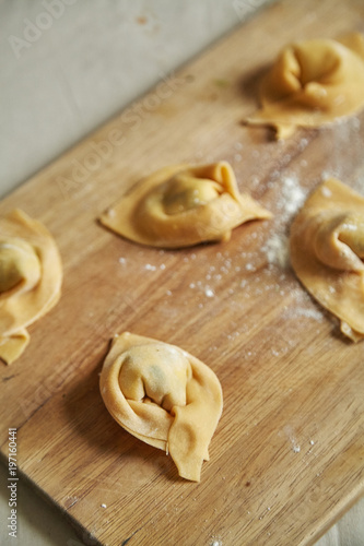 Overhead view of traditional italian handmade ravioli on cutting board