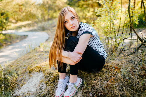 Young amazing beautiful girl outdoor nature portrait. Fashionable stylish teen with passionate expressive face posing at camera. Blue eyed lovely fabulous brunette woman relaxing in summer wonderland. photo