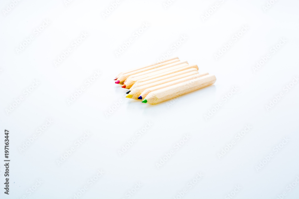Wooden color pencils isolated on a white background. Concept of knowledge and education Wooden color pencils isolated on a white background. Concept of knowledge and education