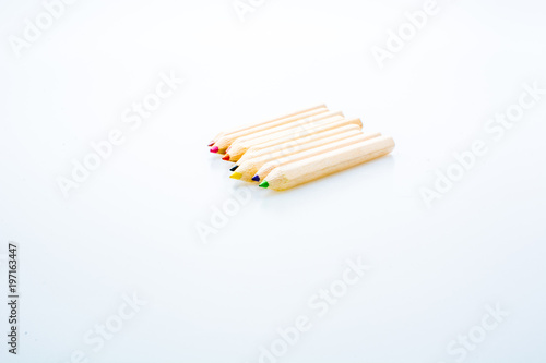 Wooden color pencils isolated on a white background. Concept of knowledge and education