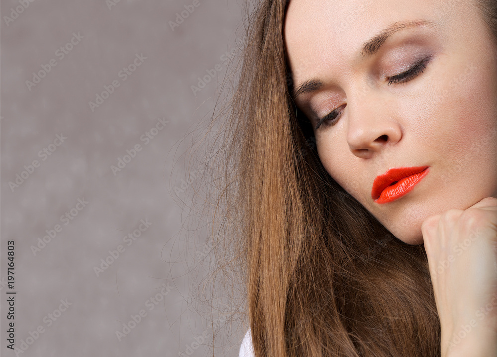 Sexy young lady with orange lipstick. Closeup