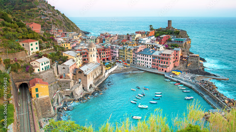Magical landscape with boats in the bay and colored houses on the rock in Vernazza, Cinque Terre, Italy, Europe