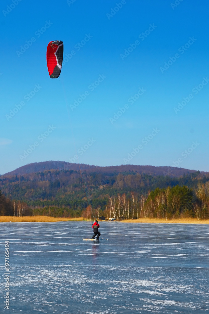 Snow kiter glides on the ice. 4th of February 2018, Machovo lake, Czech Republic.