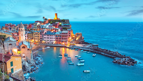 Magical landscape with boats in the bay and colored houses on the rock in Vernazza, Cinque Terre, Italy, Europe at night photo