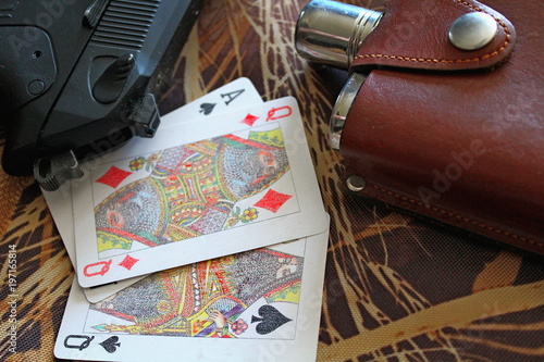 Wallpaper Mural Flask with alcohol and playing cards on camouflage material. Torontodigital.ca