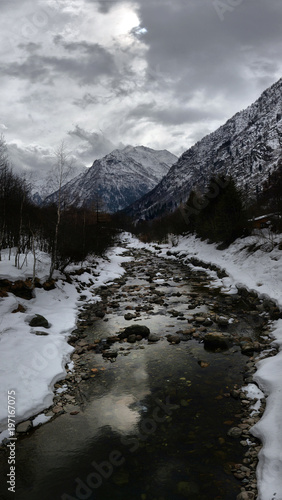 Alpine mountain river in winter on a cloudy day © nikitos77