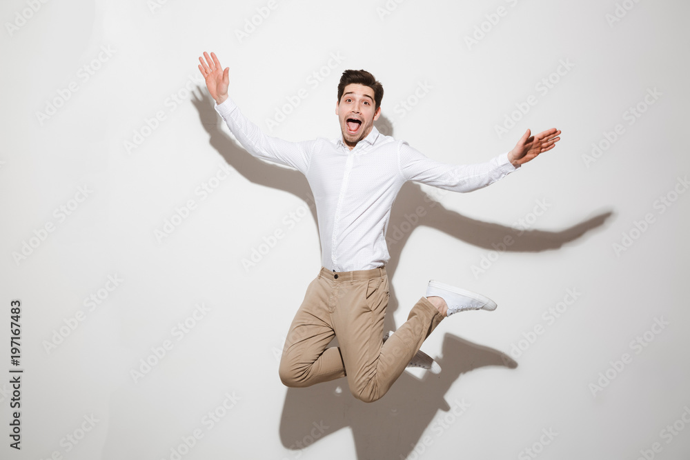 Full length portrait of an excited young man