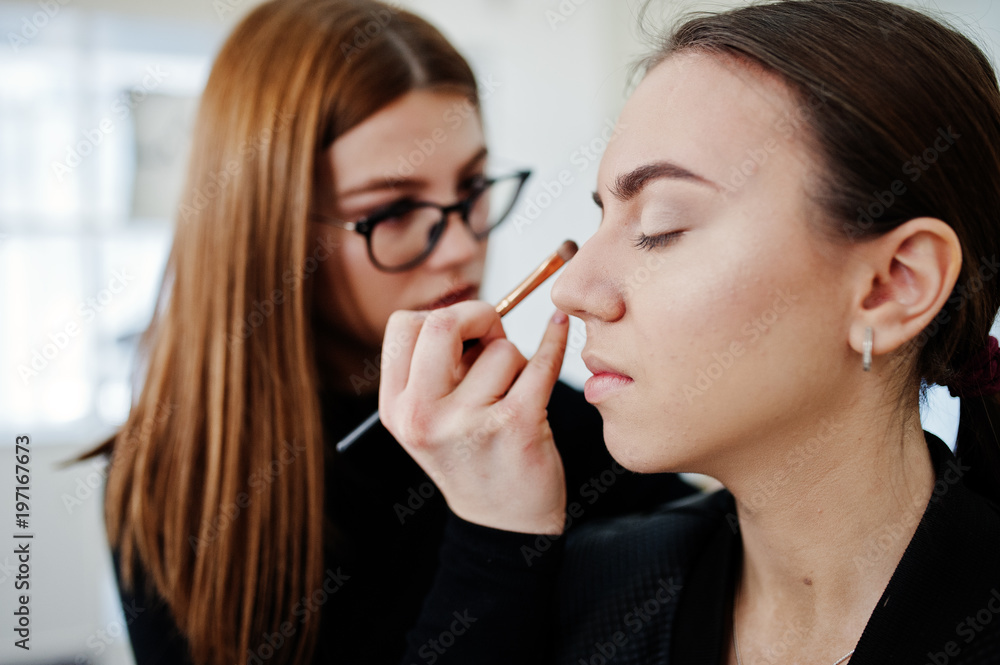 Make up artist work in her beauty visage studio salon. Woman applying by professional make up master. Beauty club concept. Make up artist work in her beauty visage studio salon. Woman applying by professional make up master. Beauty club concept.