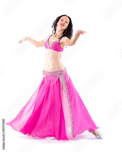 Dancer brunette girl with long hair in red oriental costume posing and dancing