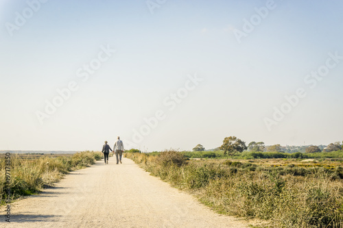 Elderly couple in love walking on a dust road, Portugal