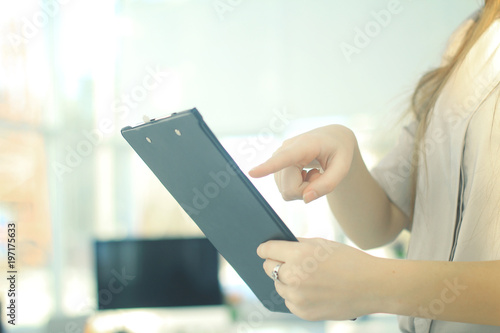 closeup.business woman reviewing the conditions of the contract.