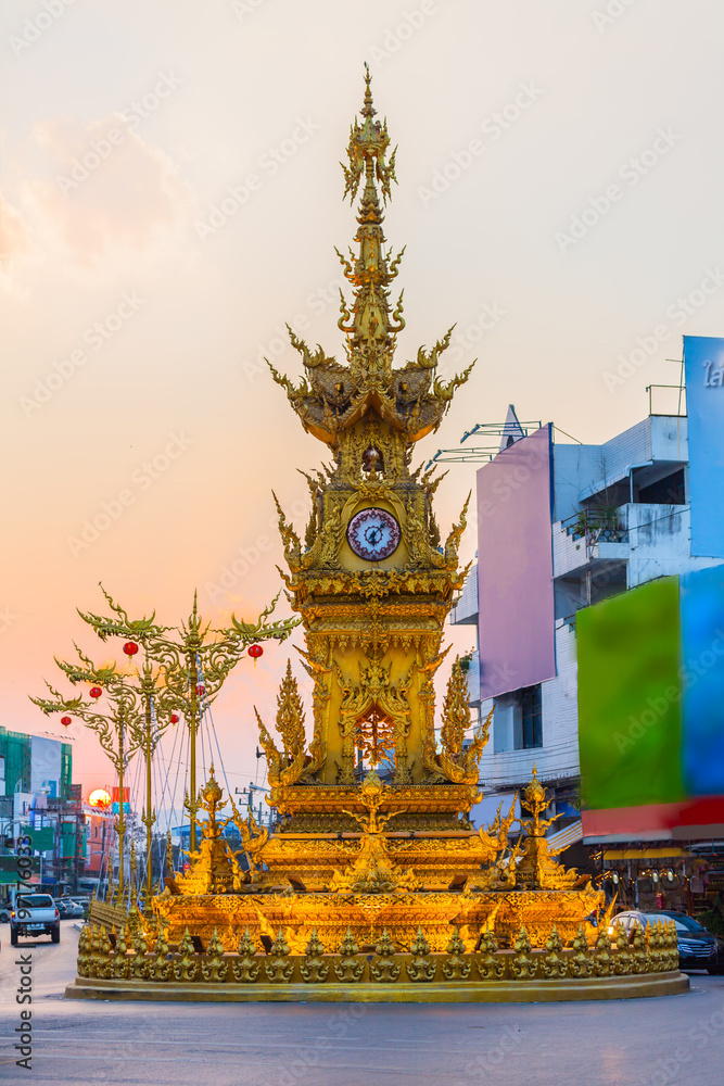 sunset at clock tower in Chiang Rai town. beautiful sculpture clock tower in central of Chiang Rai city.the color of clock tower start to change in twilight