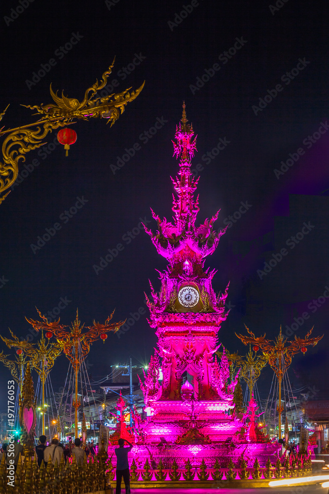 sunset at clock tower in Chiang Rai town. beautiful sculpture clock tower in central of Chiang Rai city.the color of clock tower start to change in twilight