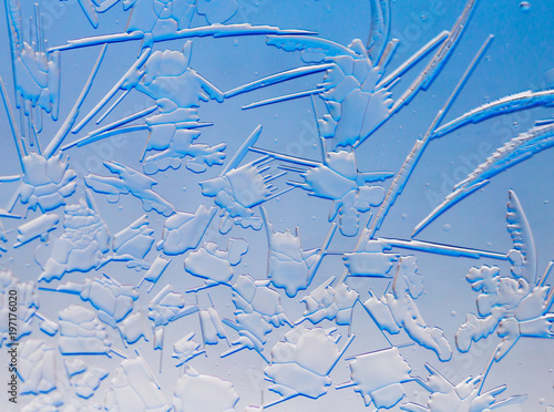 Blue drawings on the glass in the frost