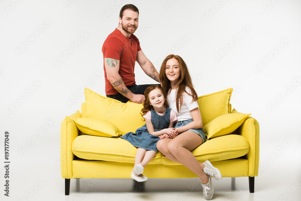 Happy family sitting on couch isolated on white Happy family sitting on couch isolated on white