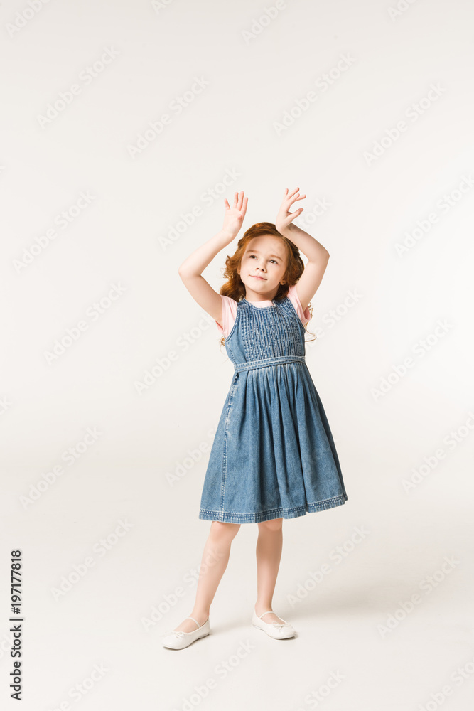 Little stylish child with arms up isolated on white Little stylish child with arms up isolated on white