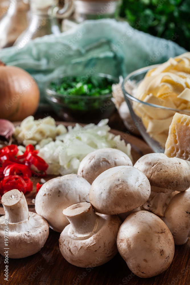 Ingredients ready for prepare tagliatelle pasta with champignon