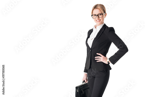 Young businesswoman wearing suit and holding briefcase isolated on white