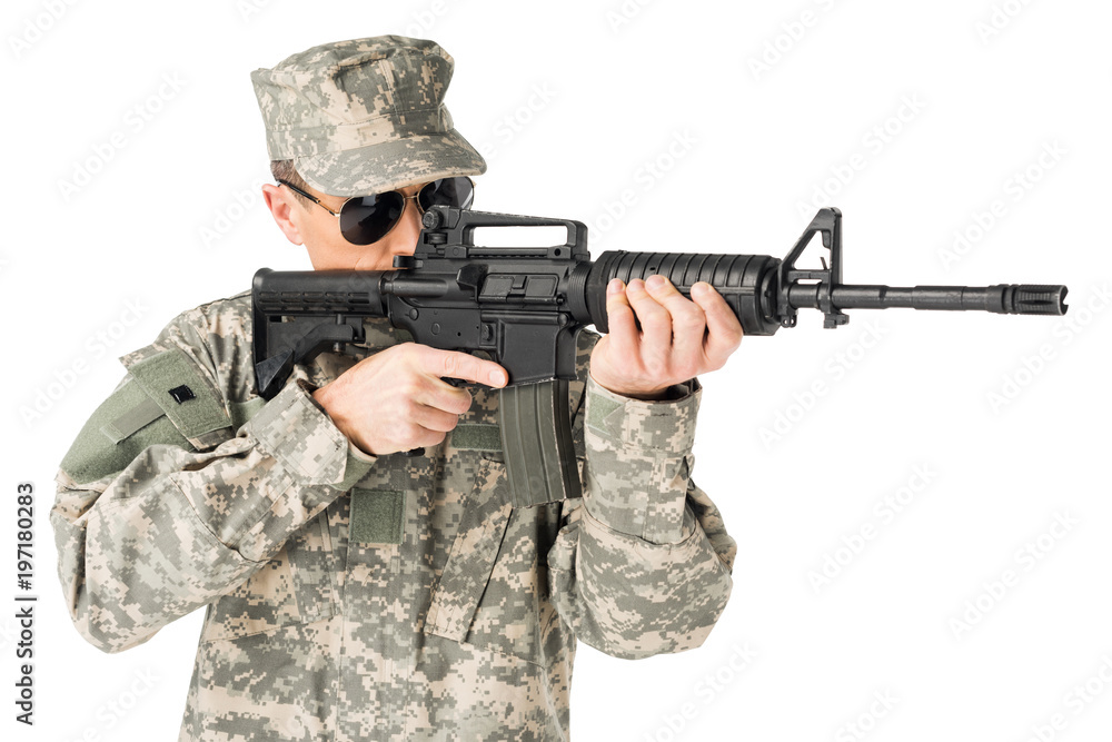 Handsome army soldier wearing uniform aiming with gun isolated on white Handsome army soldier wearing uniform aiming with gun isolated on white