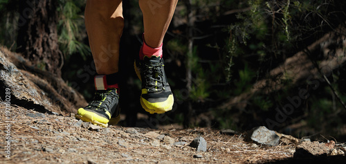 Trail running man on mountain path exercising,sports shoes detail