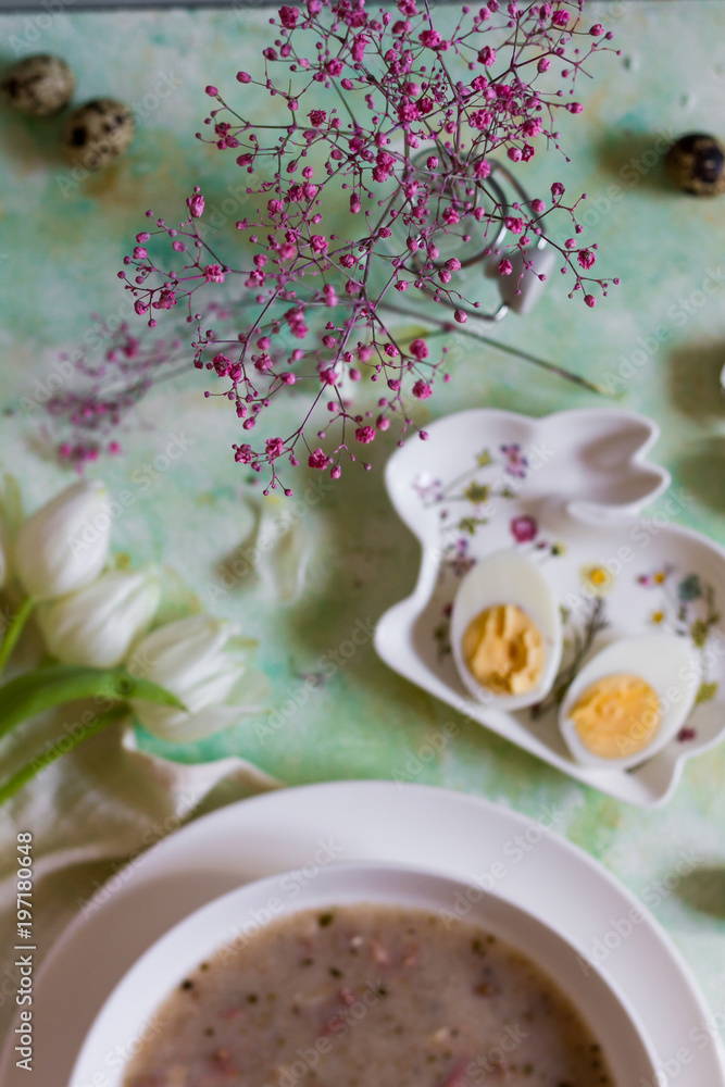 Polish traditional sour soup, zurek. Light background, eggs and tulips. White plate.
Polish traditional sour soup, zurek. Light background, eggs and tulips. White plate.
