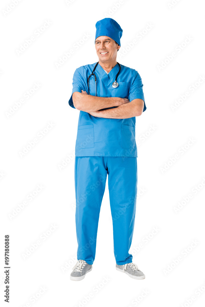 Smiling male doctor with stethoscope standing with arms folded isolated on white Smiling male doctor with stethoscope standing with arms folded isolated on white