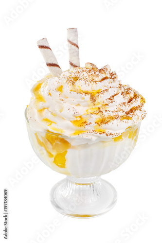 Ice cream dessert with whipped cream isolated on a white background in a high transparent glass with pineapple, apricot, orange, pumpkin jam, wafer tubules. Dessert for a menu side view
