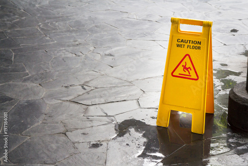 Canvas Print wet floor sign with water drops on wet stone floor